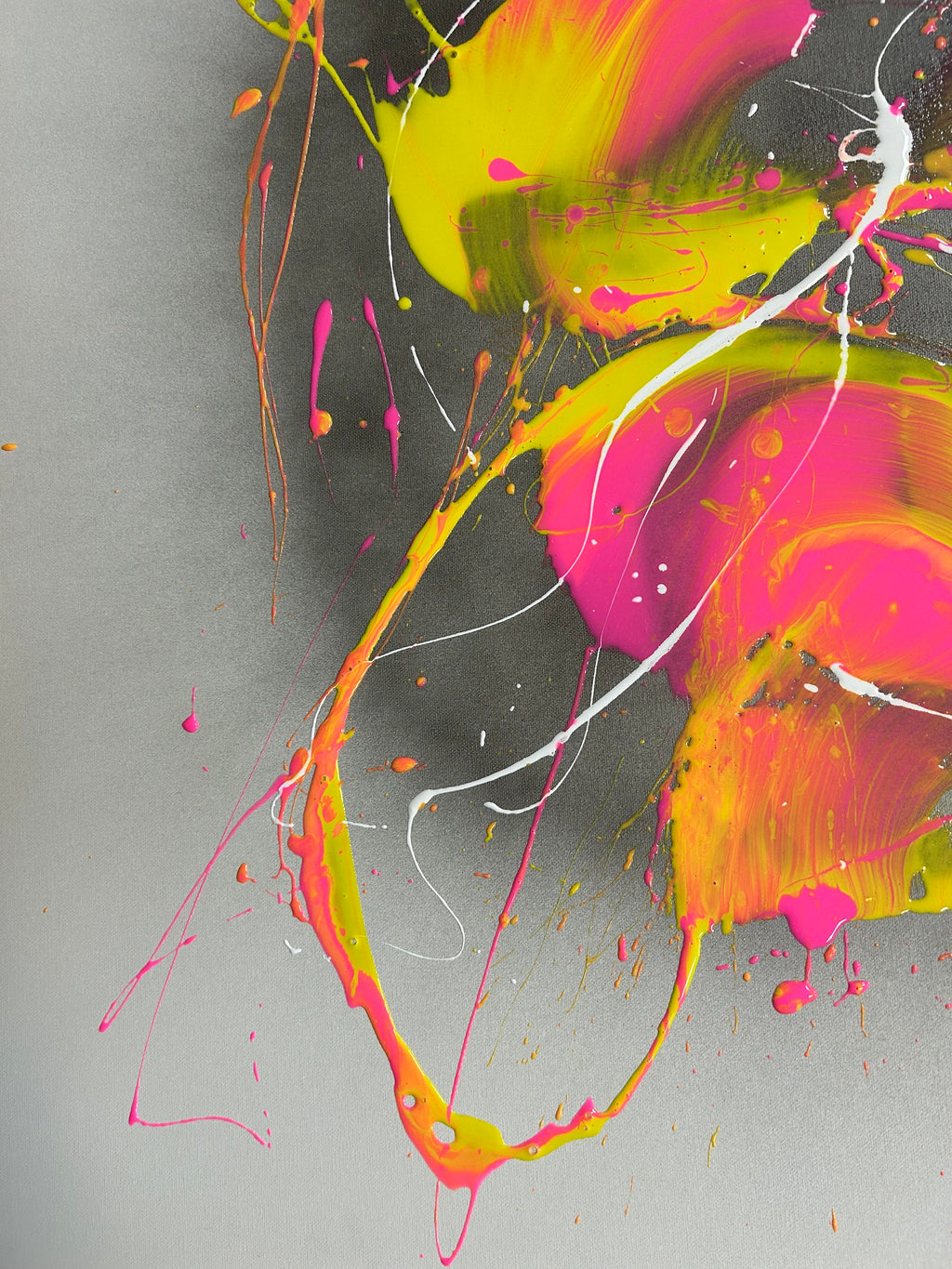 Abstract art with vibrant pink, yellow, and white splashes on a gray background