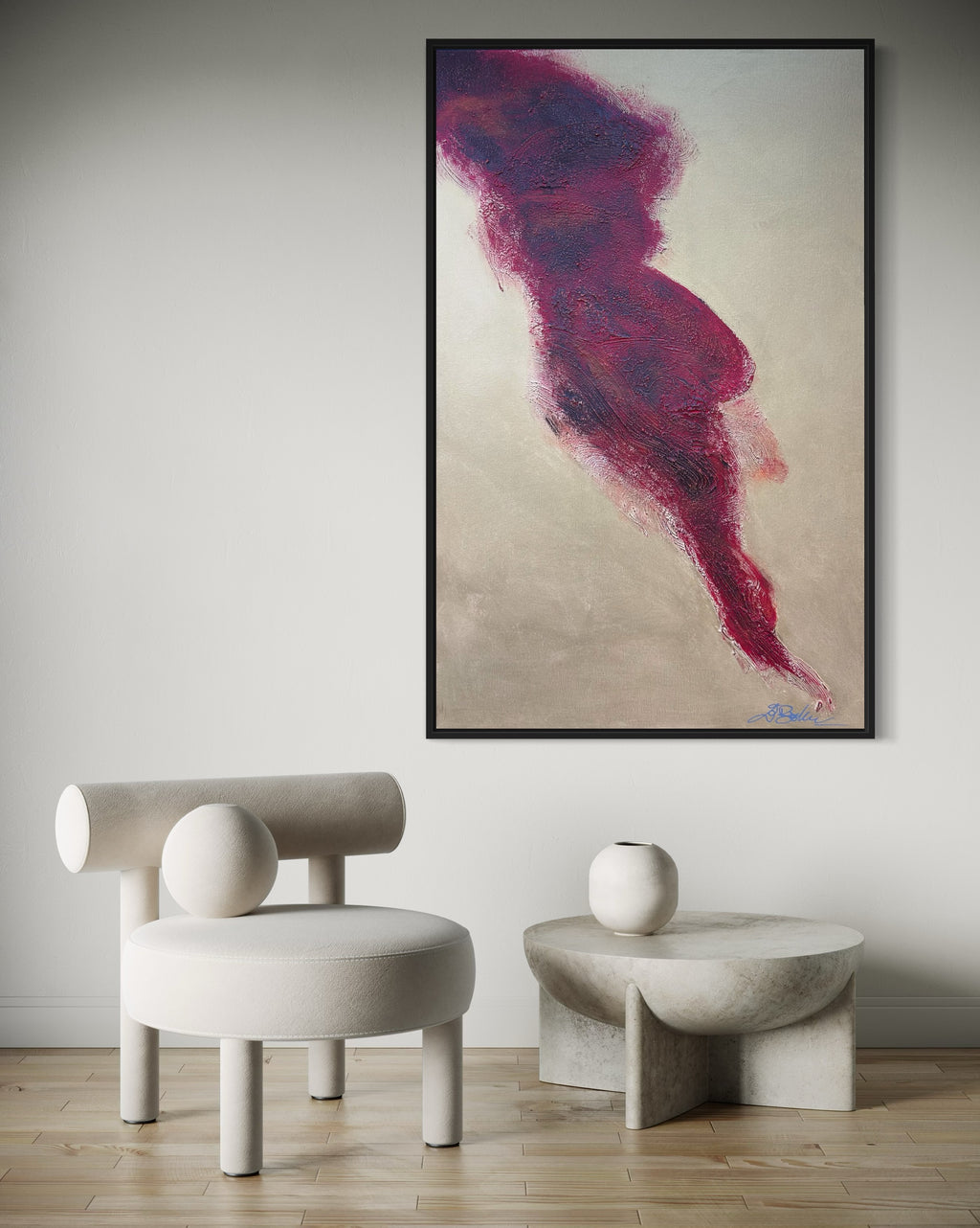 Abstract art piece in a modern interior setting with a chair and table.