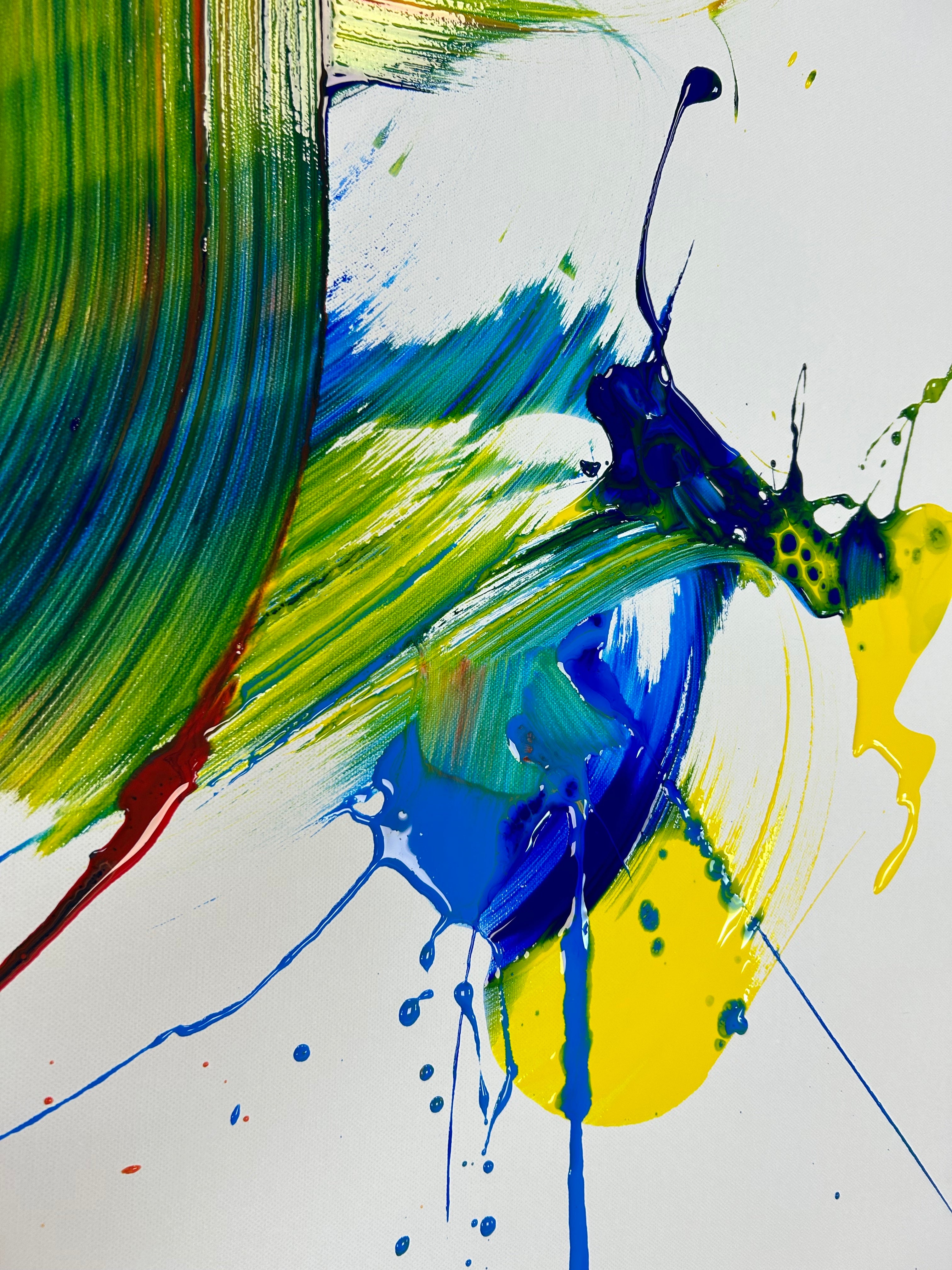 Abstract painting with splashes of green, blue, and yellow on a white background