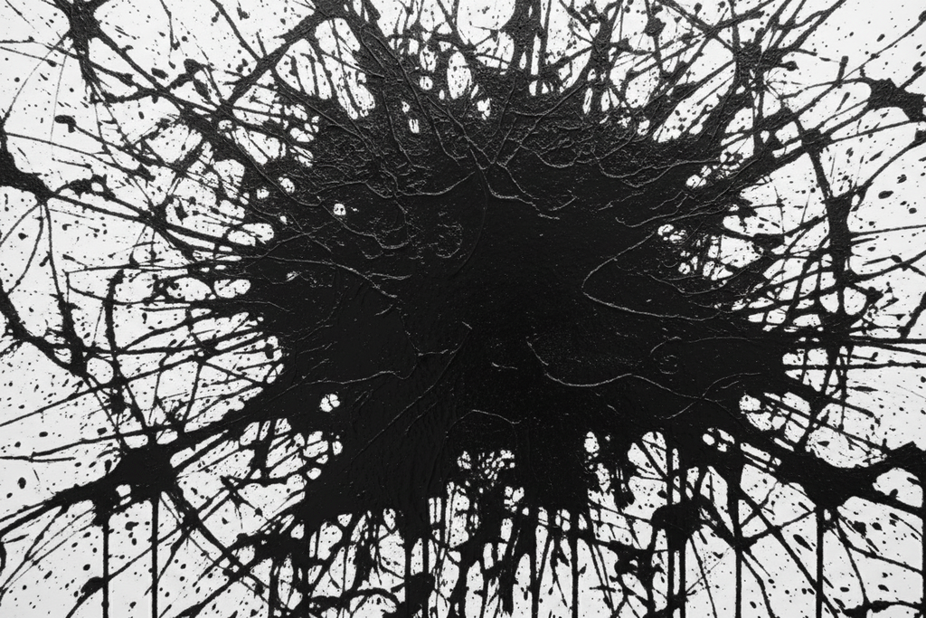 Black abstract splatter pattern on a white background