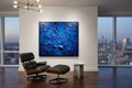 Modern interior with a blue abstract painting, Eames chair, and cityscape view.